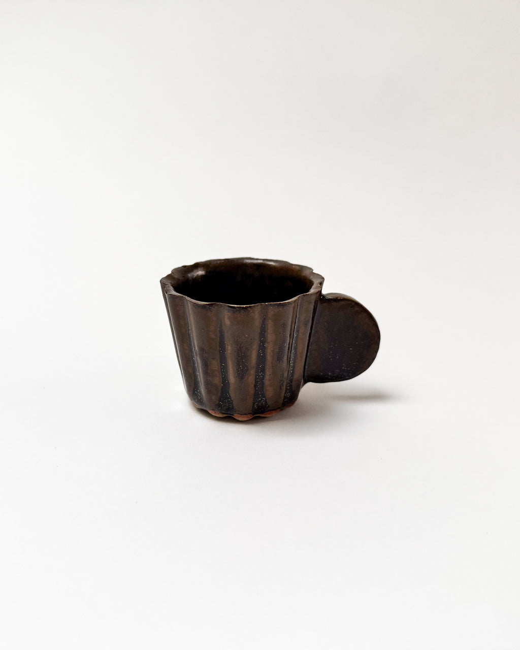 Ceramic cup with a handle on a white background